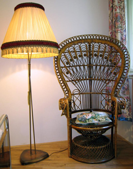 
Master bedroom detail picture of Art Deco wicker chair and lamp in Benediktska 2 Apartment in Prague, a Prague rental apartment close to Prague’s Tyn Church, Obecni Dum and Charles Bridge.  