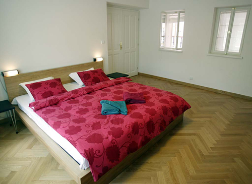 
Master bedroom with windows looking into the courtyard  in Janska 7 apartment 5 offered by Apartaments in Prag.  Prague Hotel apartment accommodation is offered  by accommodation in Prague and apartments in Prague. This short-term apartment rental Accomodations is close to Prague’s Charles Bridge and Malostranske Namesti is in Mala Strana and is offered by apartments in Prague