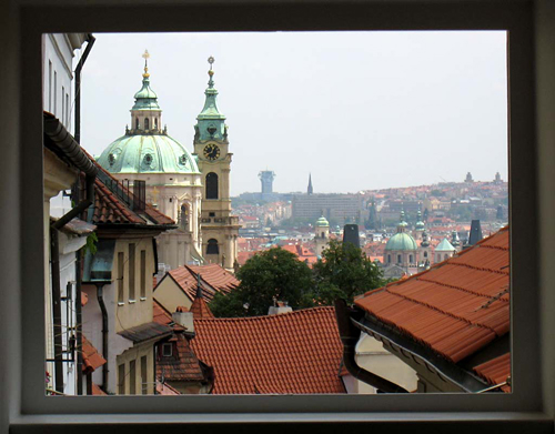 
View from Apt. 9’s master bedroom  in Residence Janska, appartment 9 an apparatment in Prague. Apt. 9 is offered by Prague Accommodations and is better than a hotel in Prague. This apartment Accomodation is close to Prague’s Charles Bridge and Malostranske Namesti and is in Mala Strana and it has lovely views of Prague’s Strahov Monastery and Petrin Hill.